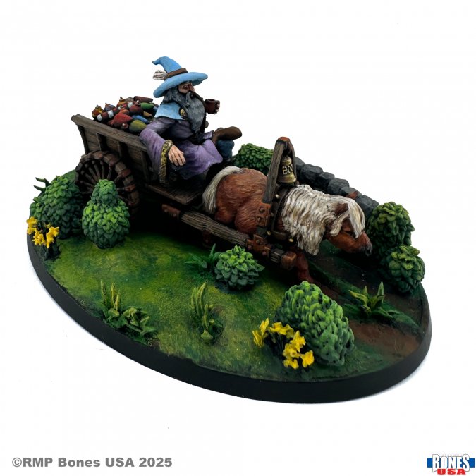 Asterius the Fire Peddlar (Unpainted) - Unpainted miniature of a cloaked figure with a wide-brimmed hat riding a wooden cart pulled by a bear on a grassy base with.