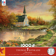Thomas Kinkade - Chapel of Reflection - 1000 Piece Jigsaw Puzzle - 1000-piece jigsaw puzzle featuring a autumnal lakeside chapel with a steeple, surrounded by fall foliage and a glowing.