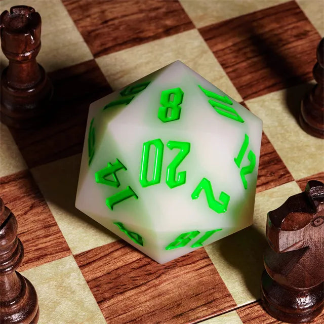 Giant Bouncy D20 - UV Color Change Green - Large white 20-sided dice with glowing green numbers designed for bouncy play on a chessboard.