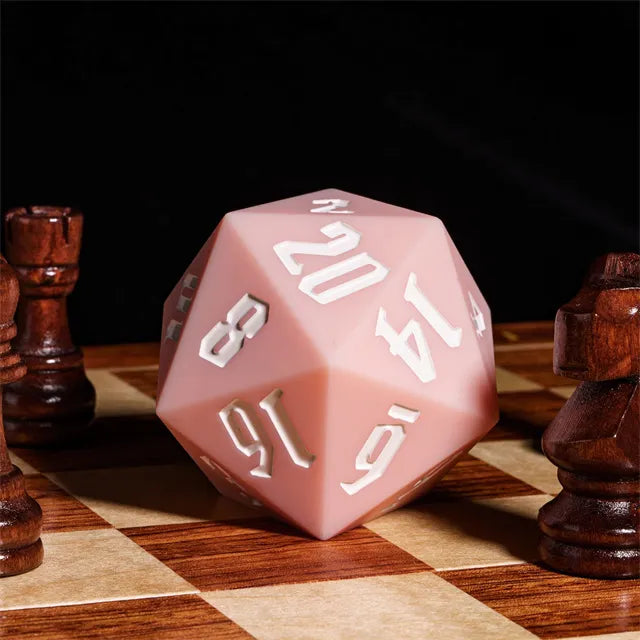 Giant Bouncy D20 - Pink - Large pink 20-sided foam die with white numbers on a chessboard with wooden chess pieces nearby.