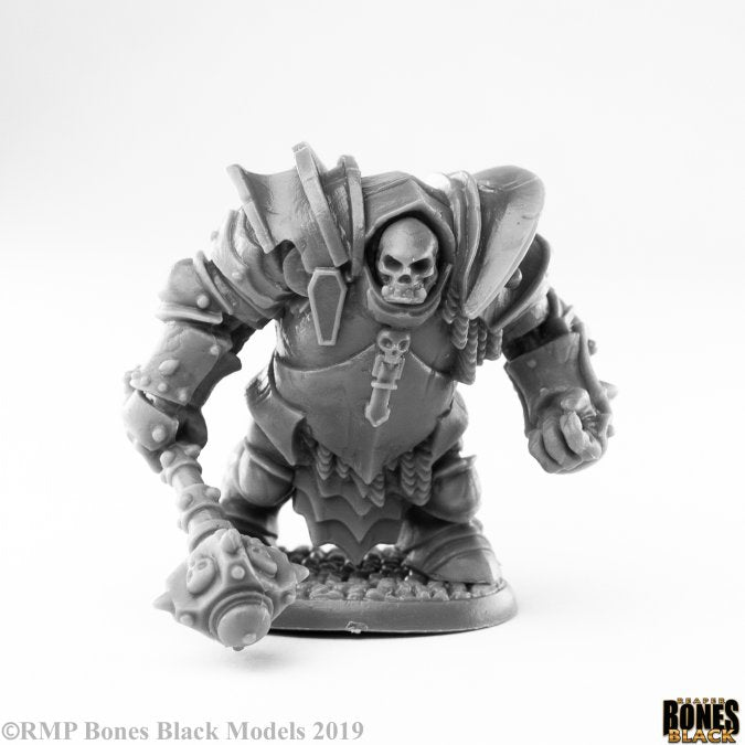 Maggotcrown Ogre Juggernaut - Unpainted detailed fantasy ogre miniature with skull helmet and heavy armor wielding large gauntlet weapon.