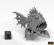 Terror Fish - Gray fantasy fish figurine with sharp teeth, spiked dorsal fin, and clawed pectoral fins next to a small block.