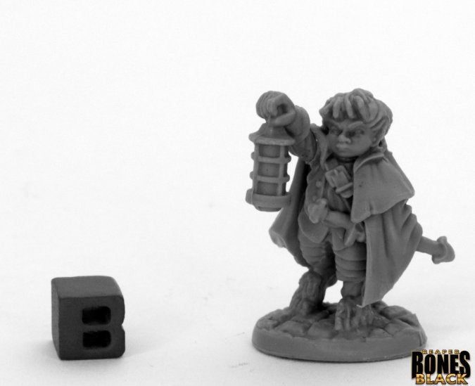 Bones Black: Bergamot, Halfling Scout - Gray miniature of a halfling scout holding a lantern and wearing a cloak on a round base.