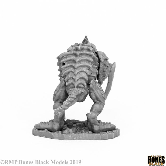 Gloom Stalker - Gray miniature figure of a reptilian humanoid creature with armor and a weapon, standing on a textured base.