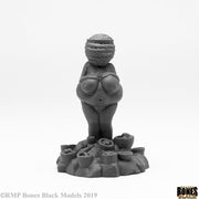 Fertility Idol - Black fertility idol sculpture with pronounced feminine features standing on a base of rounded shapes.
