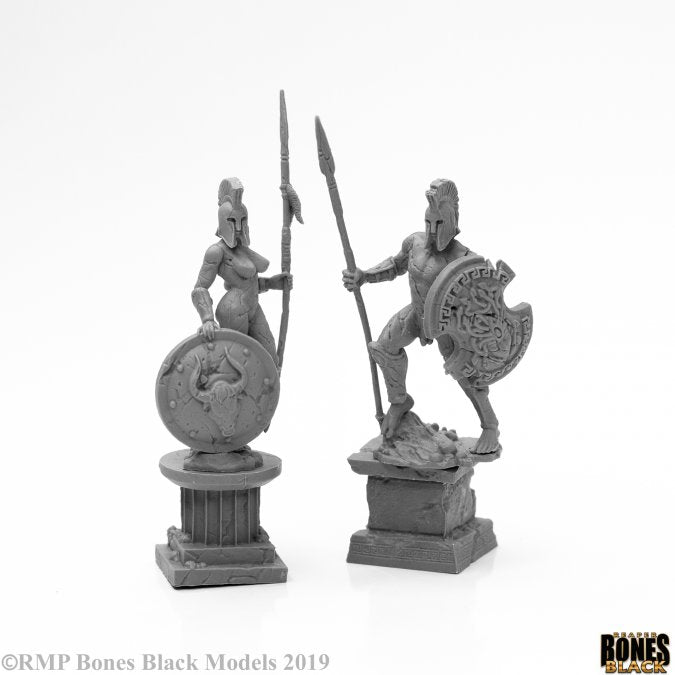 Amazon and Spartan Living Statues (Stone) - Detailed stone statues of Amazon warrior and Spartan soldier, each holding spear and round shield on pedestal bases.
