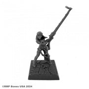 Hildi, Steampunk Heroine - Gray resin miniature of a female steampunk warrior wielding a long-barreled rifle, standing on a textured stone base.