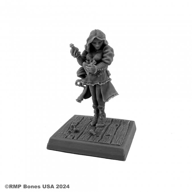 Sara, Steampunk Alchemist - Gray resin miniature of a hooded female alchemist in boots, holding a potion bottle, standing on a textured wooden base.