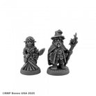 Wild West Oz - Munchkins - Two detailed gray resin fantasy miniatures, one a robed wizard with a pointed hat and staff, the other a woman in a long.