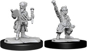 D&D Nolzur's Marvelous Minis: Gnome Artificer Male - Unpainted gray plastic miniature of a male gnome artificer holding a book in one hand and a staff in the other, wearing.