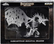 Pathfinder Battles Deep Cuts: Gargantuan Skeletal Dragon - White skeletal dragon mini with large wings and detailed bones in black and dark gray box packaging.