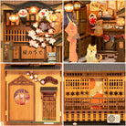 Under the Sakura Tree Book Nook (PREORDER) - Wooden book nook miniature with sakura blossoms, paper lanterns, a cat figure, and a cozy Japanese street scene.
