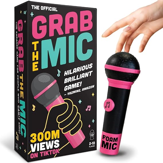 Grab The Mic: Karaoke Battle (PREORDER) - Black foam microphone with pink accents next to colorful game box reading "Grab The Mic" with hand holding microphone.