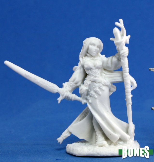 Lysette, Female Elf - White unpainted female elf fantasy figurine holding a sword in one hand and a staff in the other against a blue background.