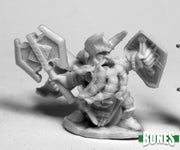 King Axehelm of Kragmarr - Gray unpainted miniature of a muscular warrior wielding a large double-headed axe and shield with fantasy armor details.