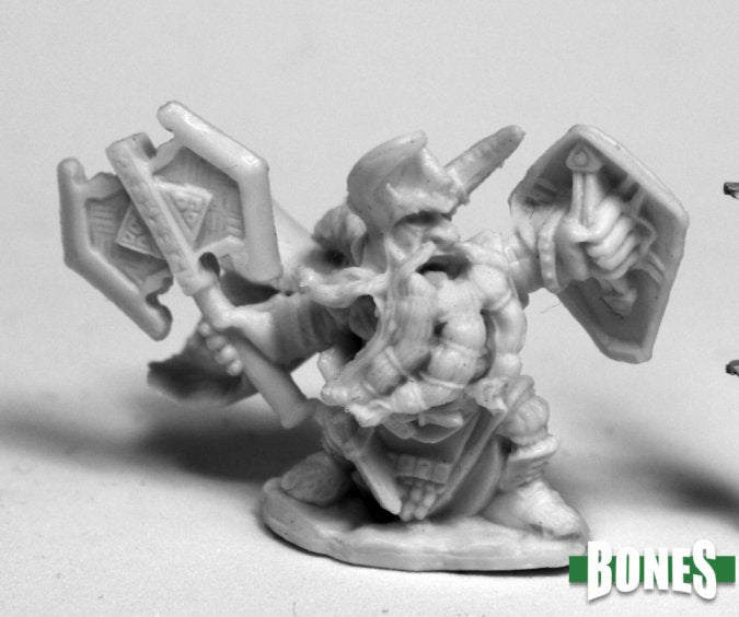 King Axehelm of Kragmarr - Gray unpainted miniature of a muscular warrior wielding a large double-headed axe and shield with fantasy armor details.