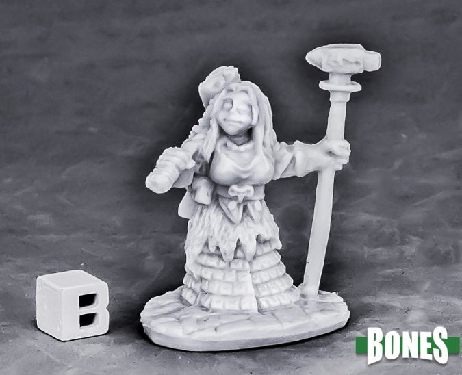Dwarf Forge Priestess - Unpainted gray resin miniature of a female dwarf priestess holding a tall staff with a hammer top, wearing layered robes and