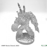 Loot Golem - Gray resin miniature of a bulky golem covered in textured rocks and gems with large clawed hands and two upright legs on a.