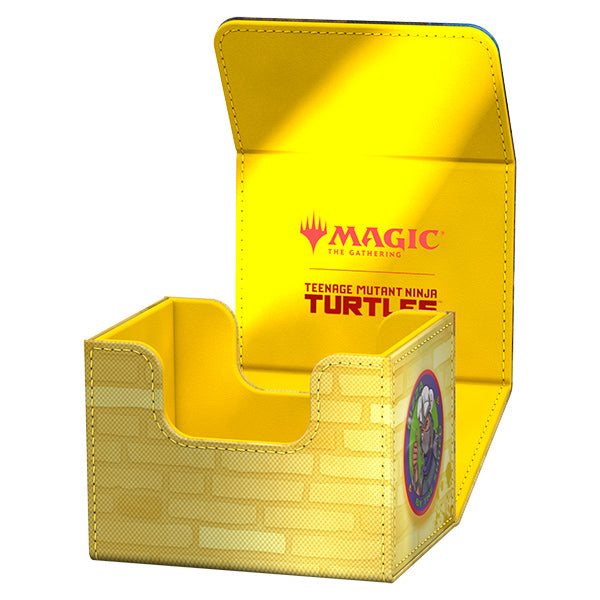 Ultimate Guard Sidewinder 100+ Xenoskin Deck Case: Teenage Mutant Ninja Turtles - Plains - Yellow rectangular card deck case with brick pattern and Teenage Mutant Ninja Turtles logo inside flap and on side panel.