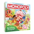 Monopoly: Strawberry Shortcake - Colorful Monopoly board game box featuring Strawberry Shortcake characters in a bright, whimsical garden setting.