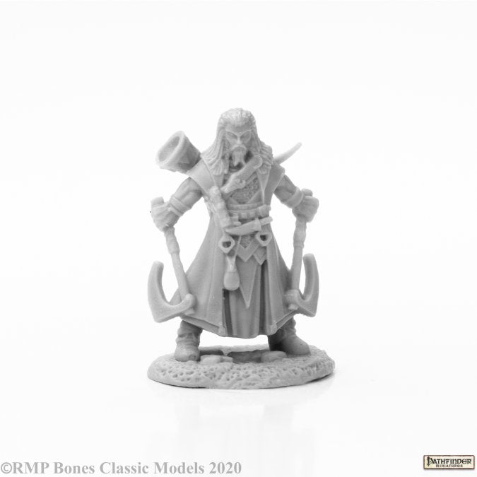 Hakon, Iconic Skald - Gray unpainted miniature figure of a bearded warrior holding two large axes, wearing a detailed tunic and armor.