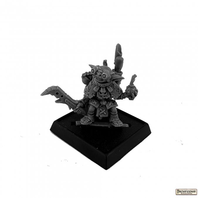 Fumbus, Iconic Alchemist - Dark gray miniature figurine of a small alchemist character with spiky hair, holding a flask and a jagged sword, standing on