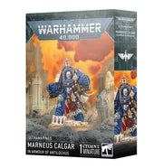 Warhammer 40,000 - Ultramarines - Marneus Calgar in Armour of Antilochus - Ultramarines Marneus Calgar miniature in blue and gold ornate power armor holding a large hammer, standing on a rocky base.