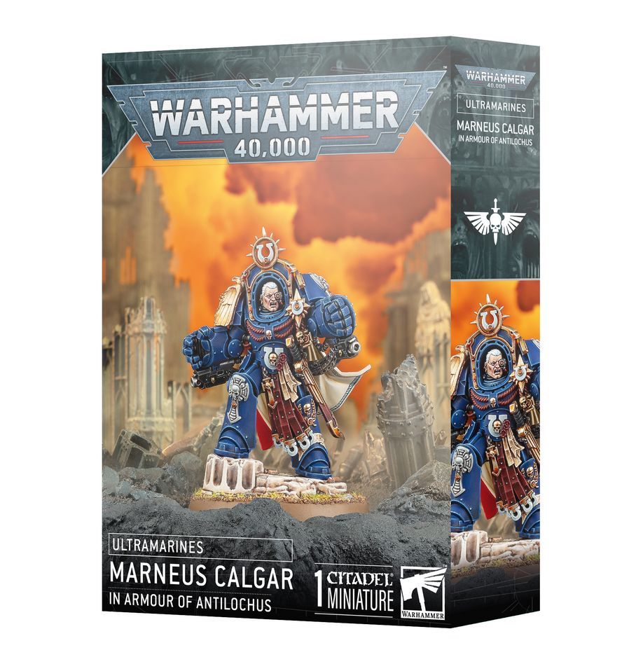 Warhammer 40,000 - Ultramarines - Marneus Calgar in Armour of Antilochus - Ultramarines Marneus Calgar miniature in blue and gold ornate power armor holding a large hammer, standing on a rocky base.