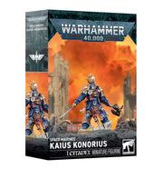 Warhammer 40,000 - Space Marines - Kaius Konorius (PREORDER) - Warhammer 40,000 Kaius Konorius Space Marine miniature with blue and gold armor, wielding a sword and mace, standing on a.