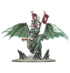 Warhammer Age of Sigmar - Helsmiths of Hashut - Urak Taar the First Daemonsmith (PREORDER) - Green winged dragon with spiked tail and metal armor ridden by armored figure holding banners on rocky base.