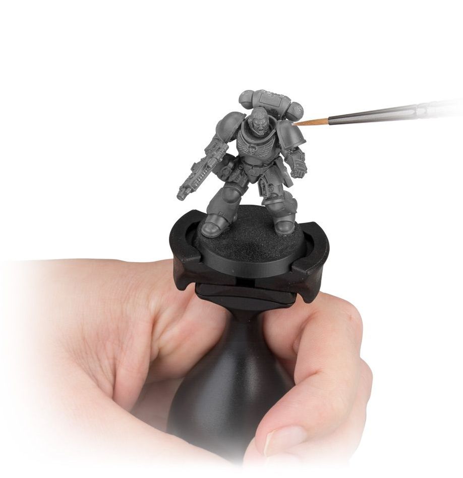 Citadel Colour - Painting Handle - Black ergonomic painting handle holding a gray miniature soldier model with a hand applying fine brush paint.