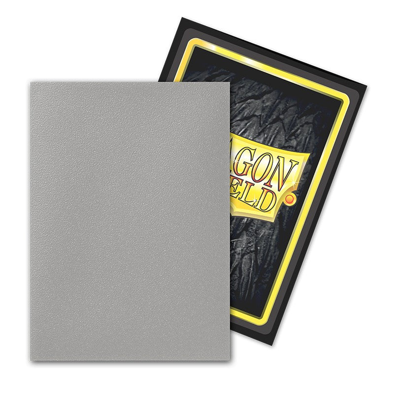 Dragon Shield Dual Sleeves 100ct Box - Matte Justice - Matte gray card sleeves partially covering black and yellow Dragon Shield box for 100 dual sleeves.