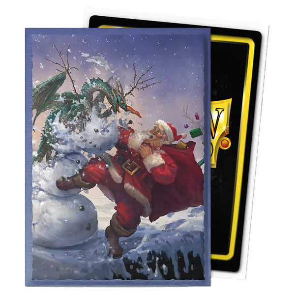 Dragon Shield Standard Brushed Art Sleeves 100ct: Christmas 2025 - Card sleeves featuring festive Santa Claus with a green dragon and snowy winter scene, blue background.