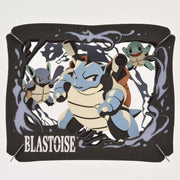 Ensky Pokémon Paper Theatre - Blastoise - Black layered paper diorama featuring blue Blastoise and two smaller Squirtle characters surrounded by water splash effects.