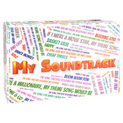 My Soundtrack (PREORDER) - Rectangular white game box covered in colorful song title phrases with bold orange and yellow "My Soundtrack" text on the.