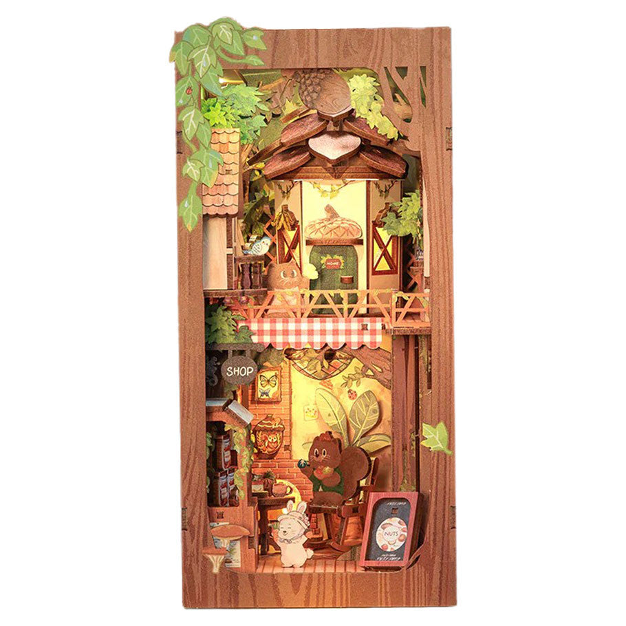 Squirrel Collector Book Nook (PREORDER) - Wooden book nook featuring cozy miniature cabin scene with squirrel, rustic furniture, and leafy greenery accents.