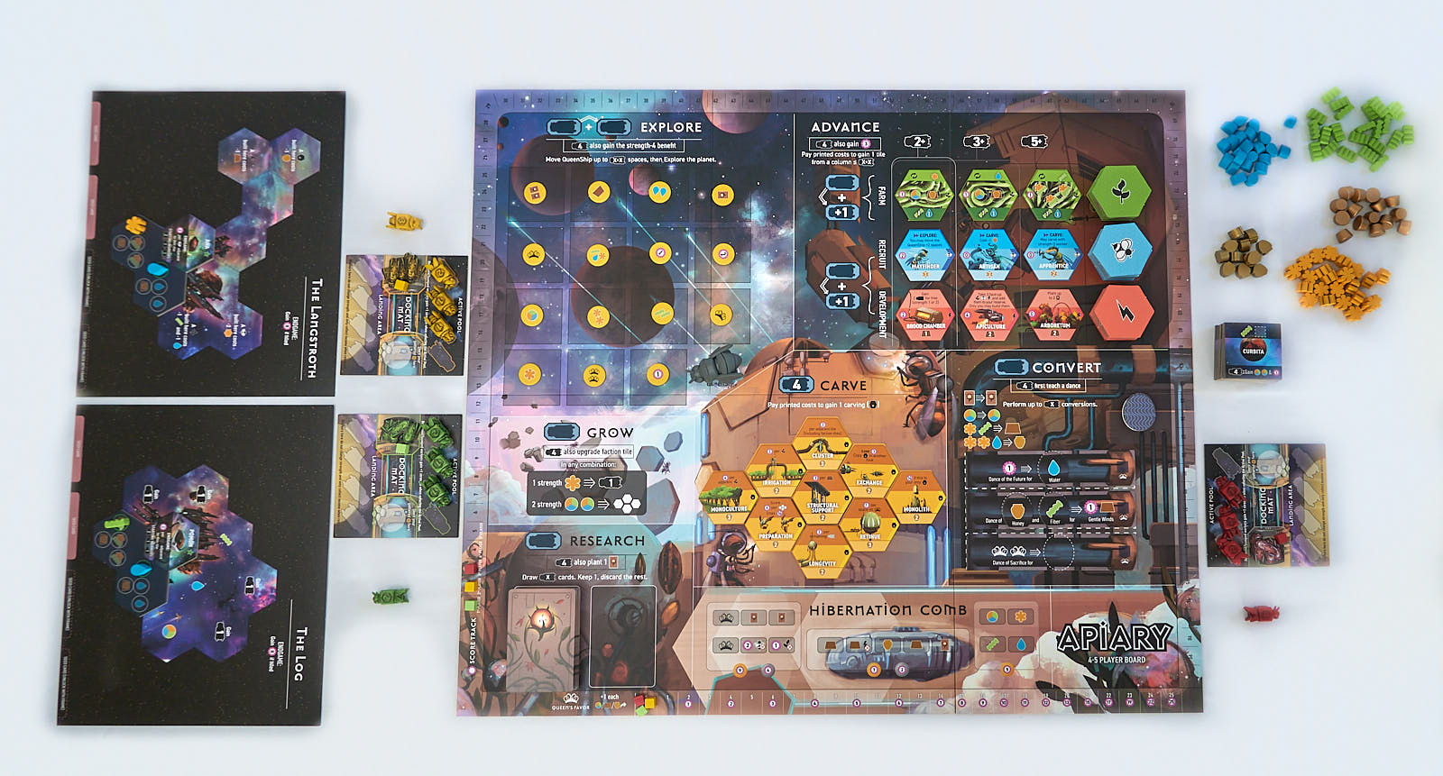 Apiary - Apiary board game setup with hexagonal honeycomb tiles, bee and flower tokens, and colorful player boards on a white surface.