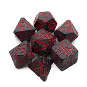 Black Cracked Slag Dice Set - Black polyhedral dice set with red crack-like veins and engraved numbers for tabletop gaming.