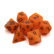 Emberlight Orange Glow-in-the-Dark Dice Set - Seven orange glow-in-the-dark polyhedral dice with black numbers, including d20, d12, d10, d8, d6, and d4 shapes.