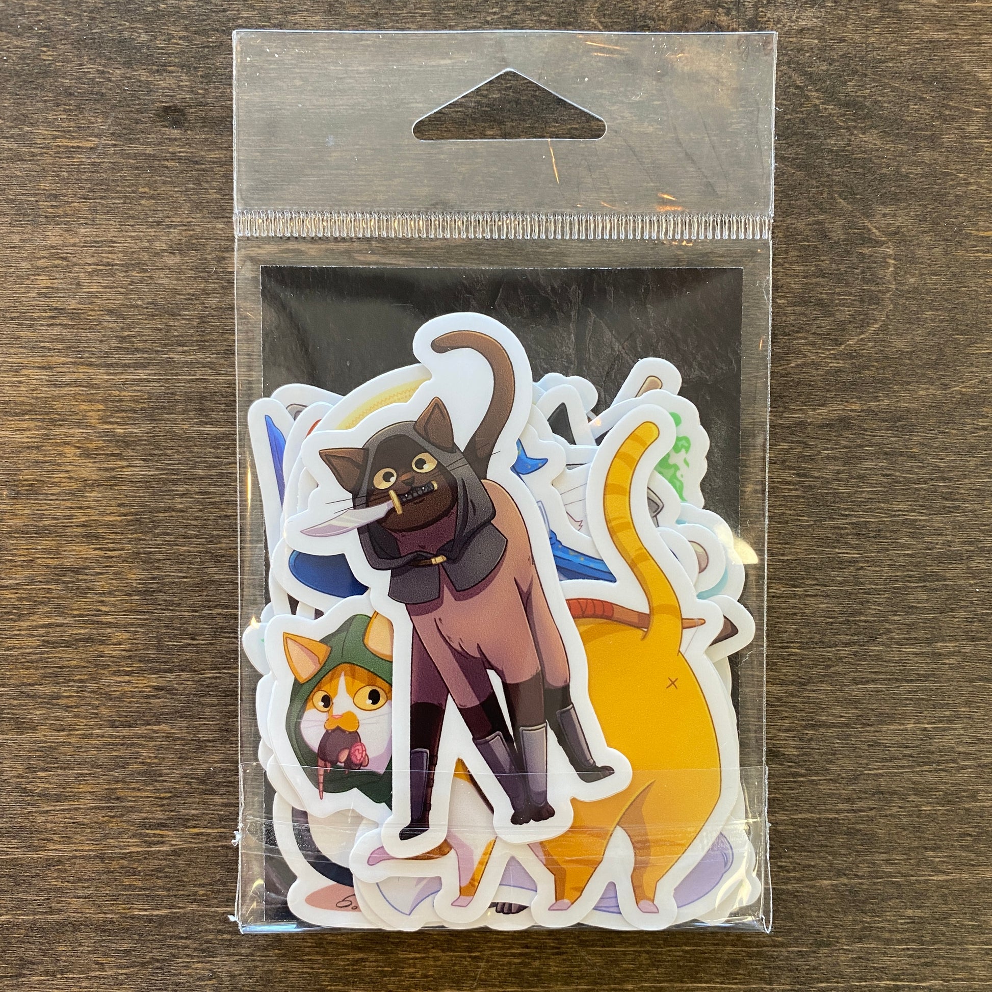 D&D Cat Sticker Pack - Pack of colorful cat stickers with playful illustrations in various poses, sealed in clear plastic bag.