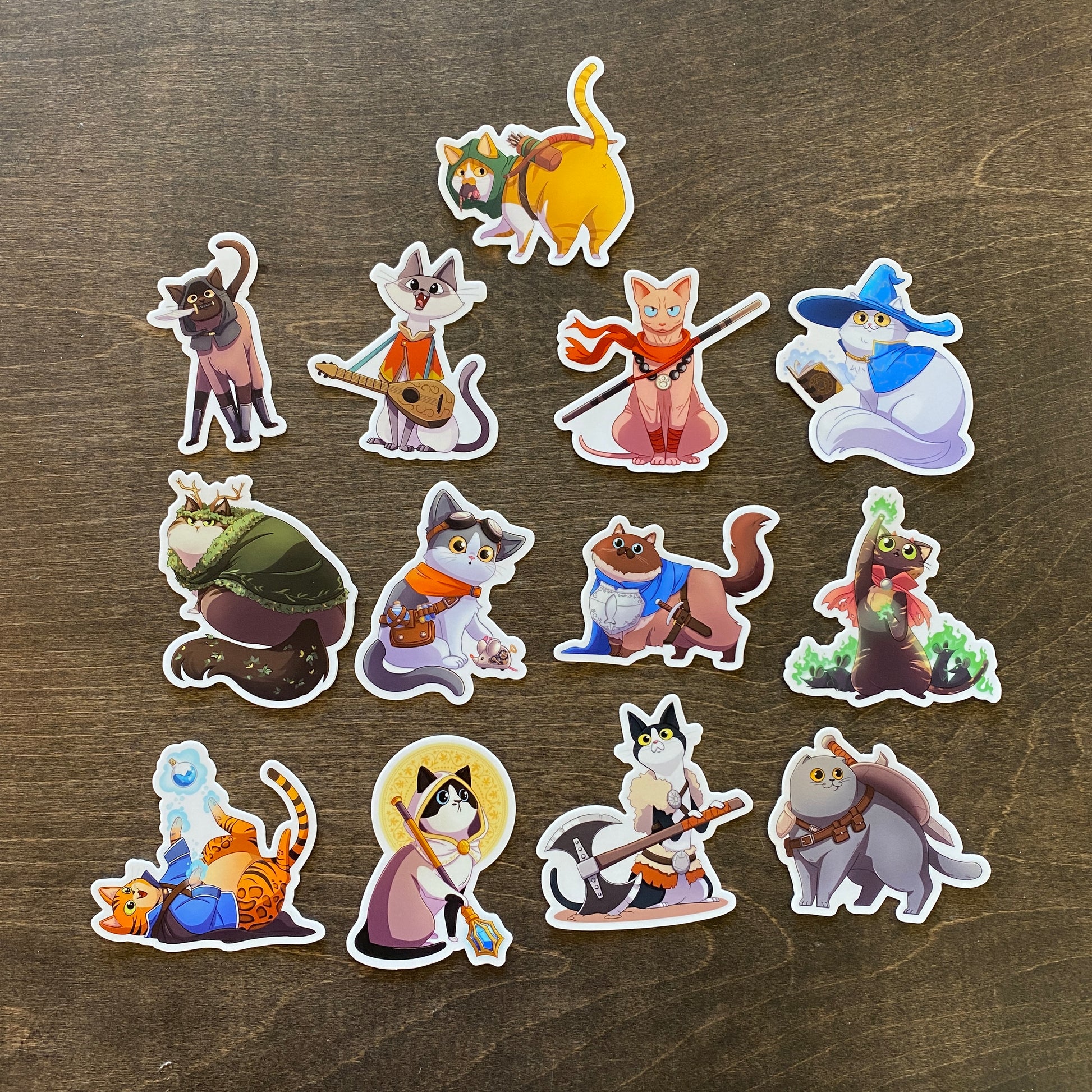 D&D Cat Sticker Pack - Colorful die-cut stickers featuring cats dressed as fantasy RPG characters like wizards, warriors, and rogues.
