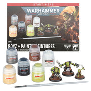 Warhammer 40,000: Boyz + Paints Set - Warhammer 40,000 Boyz + Paints Set with six paint pots, three painted Ork miniatures, and a paintbrush on black surface.