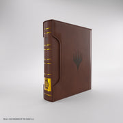 Gamegenic 18-Pocket Card Almanac: Secrets of Strixhaven - Quandrix (PREORDER) - Brown leather-like card binder with embossed black mana symbol and yellow label on spine.