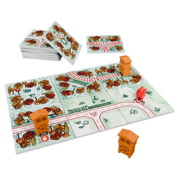 Railroad Tiles: Forest Expansion - Colorful board game tiles with railroad tracks, trees, and buildings, plus small orange wooden train pieces.