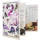 The Field Guide to Floral Dragons: GM Screen (5e) - GM screen with white background featuring vibrant purple floral dragon illustrations and detailed game tables inside.
