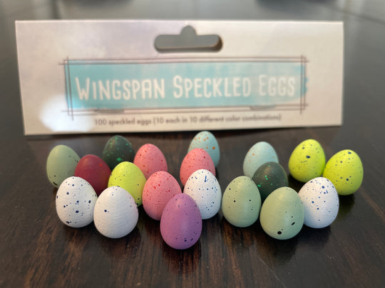 100 Speckled Eggs for Wingspan - Colorful speckled plastic eggs in pastel shades of pink, blue, green, yellow, and white arranged in rows.