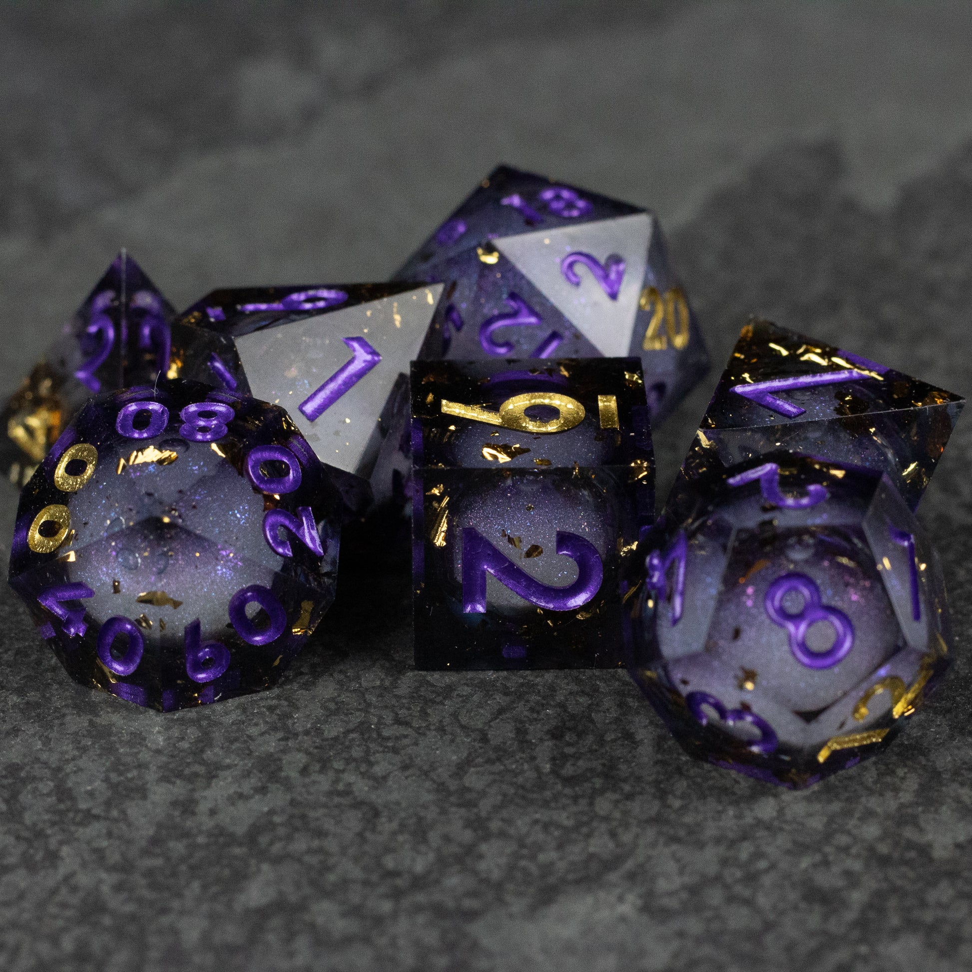Witching Hour Liquid Core Dice - Set of seven sharp-edged polyhedral dice with deep purple and black liquid core, gold numbering, and translucent edges.