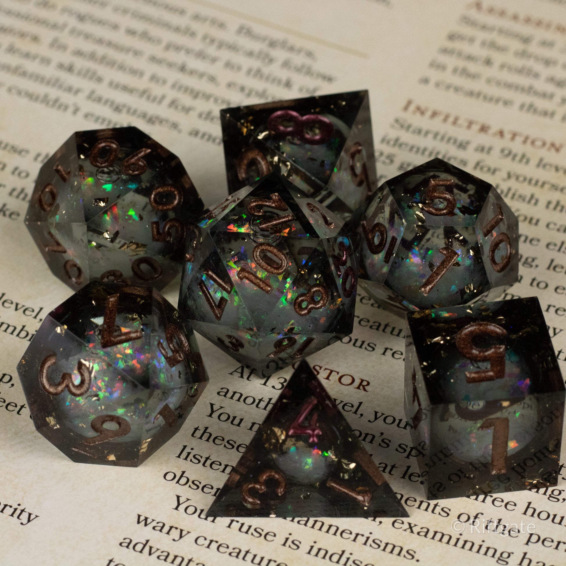 Wild Magic Liquid Core Dice Set - Seven sharp-edged polyhedral dice with black and iridescent liquid core, gold numbering.
