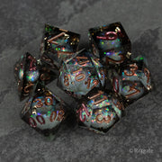Wild Magic Liquid Core Dice Set - Set of seven sharp-edged polyhedral dice with dark translucent bodies and swirling iridescent liquid cores, featuring.