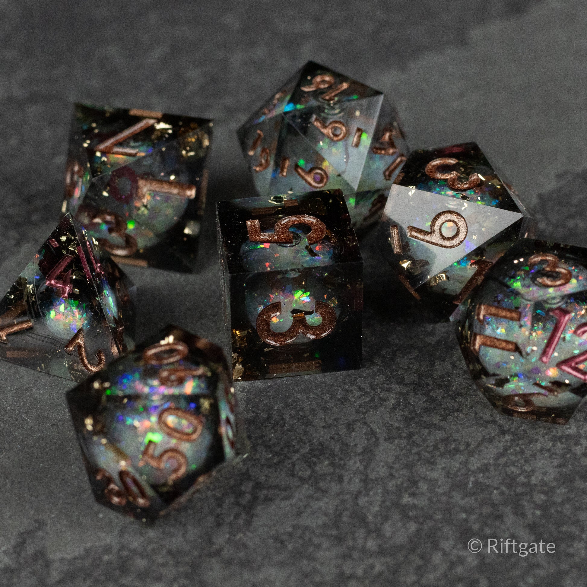 Wild Magic Liquid Core Dice Set - Set of seven translucent polyhedral dice with black liquid core, teal and purple shimmer, sharp edges, and gold numbers.